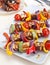 Halloumi and vegetable kebabs on a table