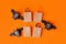 Halloween advertising mock up. Blank on paper craft package for shopping and black bats from toilet roll on orange background.