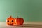 Halloween and autumn festive holiday concept. Plastic decor with scary face. Isolated on green. Copy space for text