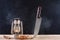 Halloween background of big knife stabbed in wooden desk and old gas lamp