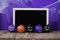 Halloween background concept. Blackboard with decor pumpkins, co