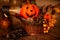 Halloween background decorated holidays festive concept. Jack o lantern pumpkin halloween decorations on wooden table. Burning