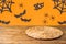 Halloween background with empty wooden table and wicker round placemat