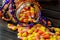 Halloween background frame consisting of a jar full of candy corn on a dark wooden table with a black table that you can personali