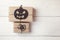 Halloween background with gifts boxes and decorative spider and pumpkin on white boards. Space for text.