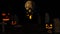 Halloween background with haunted house, ghost, bats and pumpkins, graves, at misty night spooky with fantastic big moon in sky.