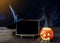 Halloween background. Spooky pumpkin, Witch hat, chalkboard on w