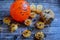 Halloween baking, orange ball with a pattern, pumpkins and spiders on a rustic background. Top view