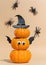 Halloween banner, cute pumpkins with eyes and funny faces. Witch hat. Set pumpkin monsters and crawling spiders