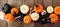 Halloween banner with orange, black and white pumpkins, bones and spiders against rustic wood