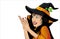 Halloween. Beautiful woman in hat and witch costume is surprised