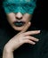 Halloween beauty portrait of young beautiful woman with green lacy ribbon on eyes