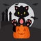 Halloween black kitten sitting on the pumpkin