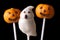 Halloween cake pop spooky and pumpkins on a black