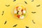 Halloween candy.Halloween holidays on yellow background, colorful decoration toys, baby sweets, donuts, marmalade. trick or treat