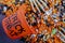 Halloween candy spilling out of orange trick or treat bucket