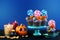 Halloween candyland drip cake style cupcakes with candy on blue background.