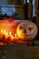 Halloween card. Jack\\\'s lantern from pumpkin and candles on a wooden staircase.