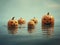 Halloween carved pumpkins floating on the water surface.