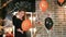 Halloween celebration, young witch playing balloon with pumpkin, teen girl wearing scary costume