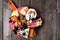 Halloween charcuterie board, above view against a dark wood background.