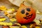 Halloween. a cheerful Halloween pumpkin among the leaves.