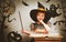 Halloween. cheerful little witch with magic wand and book conjur