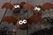 Halloween chocolate donut hole bats against dark wood
