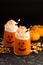 Halloween cold cocktail or drink with jack o`lantern face