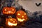 Halloween composition of burning pumpkin with bat. Cobwebs branches atmosphere