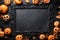 Halloween composition - multicolored pumpkins and leaves on black background, copy space, top view, greeting card, design mock up