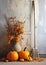 Halloween composition with pumpkins,dried tree branches, autumnal leaves and broom