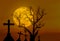 Halloween concept background with scary silhouette dead tree and spooky silhouette crosses in mystic graveyard and big full moon