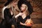 Halloween Concept - beautiful caucasian mother playing with her little daugther enjoy with Halloween candy and sweet over bats and