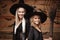 Halloween Concept - Closeup beautiful caucasian mother and her daughter in witch costumes celebrating Halloween posing with curved
