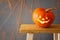 Halloween concept. Cute pumpkin on wooden table