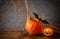 Halloween concept. Cute pumpkins and bats on wooden table