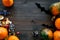 Halloween concept, halloween mood. Pumpkins and cute figures of halloween evils. Skeleton, bats. dark wooden background