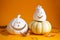 Halloween concept. Halloween pumpkins, dried leaves on yellow background. Autumn composition