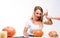 Halloween concept, happy Girl sitting at table with pumpkins pre