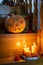 Halloween concept. Jack\\\'s lantern from pumpkin and candles on a wooden staircase.