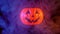 Halloween concept, moving plastic pumpkin lantern with blue-orange smoke around