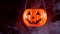 Halloween concept - moving plastic pumpkin lantern with white smoke around
