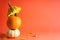 Halloween concept. Pumpkins, dried leaves on orange background, space for text. Autumn composition