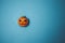 Halloween concept. Scary holiday pumpkin on an azure background with space for text, top view flat lay with scratches