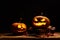 Halloween concept with scary luminous pumpkin on the old wood table with dark background