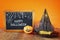 Halloween concept. Witch hat, cute pumpkin next to blackboard