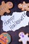 Halloween congratulation card on a burnt piece of paper and gingerbread cookies