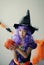 Halloween costume. Halloween witch with pumpkin