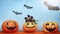 Halloween creative funny pumpkins with smile faces and paper bats on Blue Orange background